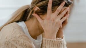 Woman Covering Her Face With Her Hands
